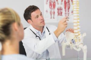 Chiropractor showing spine. Woodstock GA