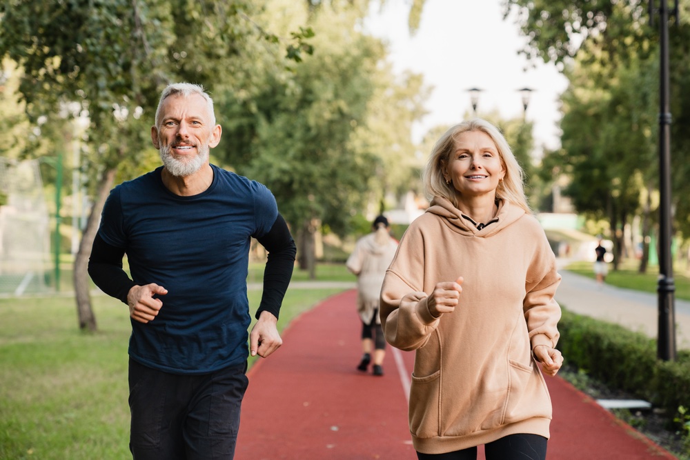 middle aged couple out on a run and feeling great thanks to testosterone replacement therapy